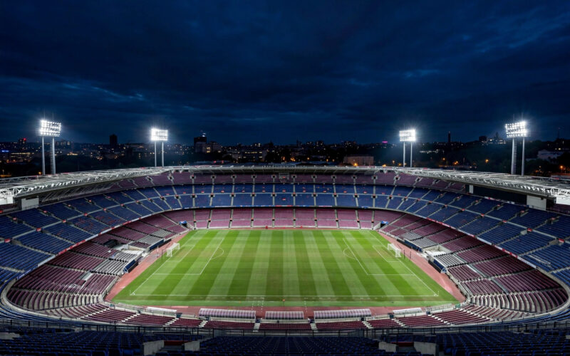 A wide view of the Camp Nou stadium under floodlights before a La Liga night match, without identifiable players.