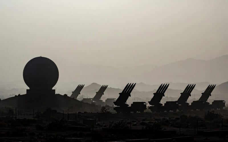 Missile defense equipment at a military installation at dusk.