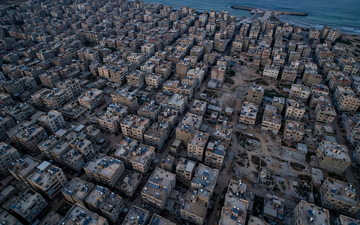Aerial view of densely built Gaza city blocks at dusk