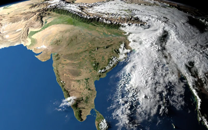 Satellite view of India from space showing clouds over the east and clear skies over the west