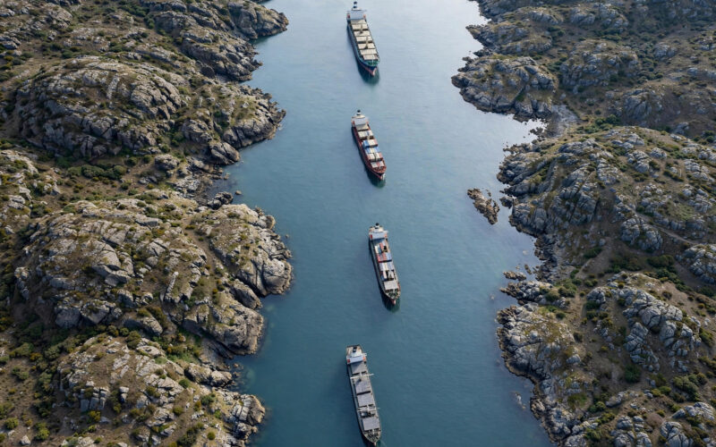 Aerial view of the Strait of Hormuz with cargo ships near the coastline