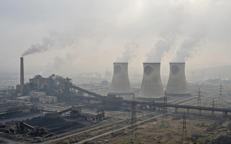 A coal-fired power plant with cooling towers and transmission lines