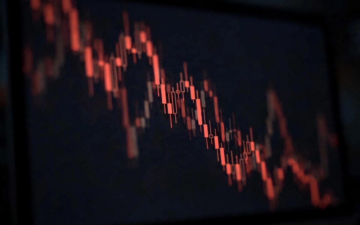 Stock market trading chart showing a sharp downward red line on a screen