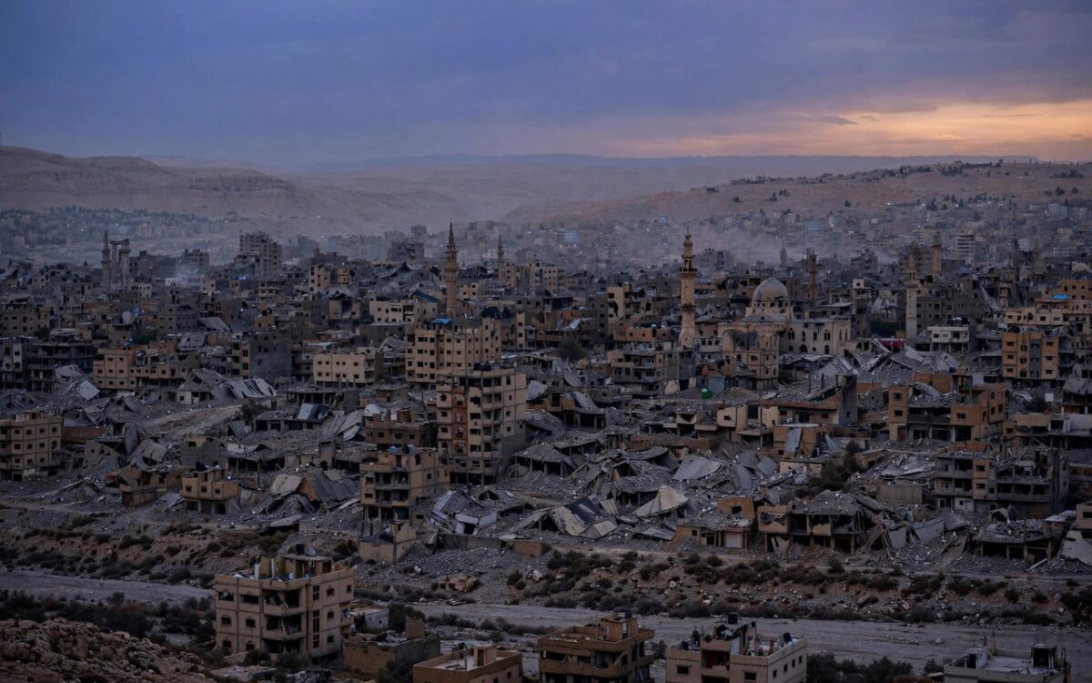 Damaged city skyline in Gaza at dusk