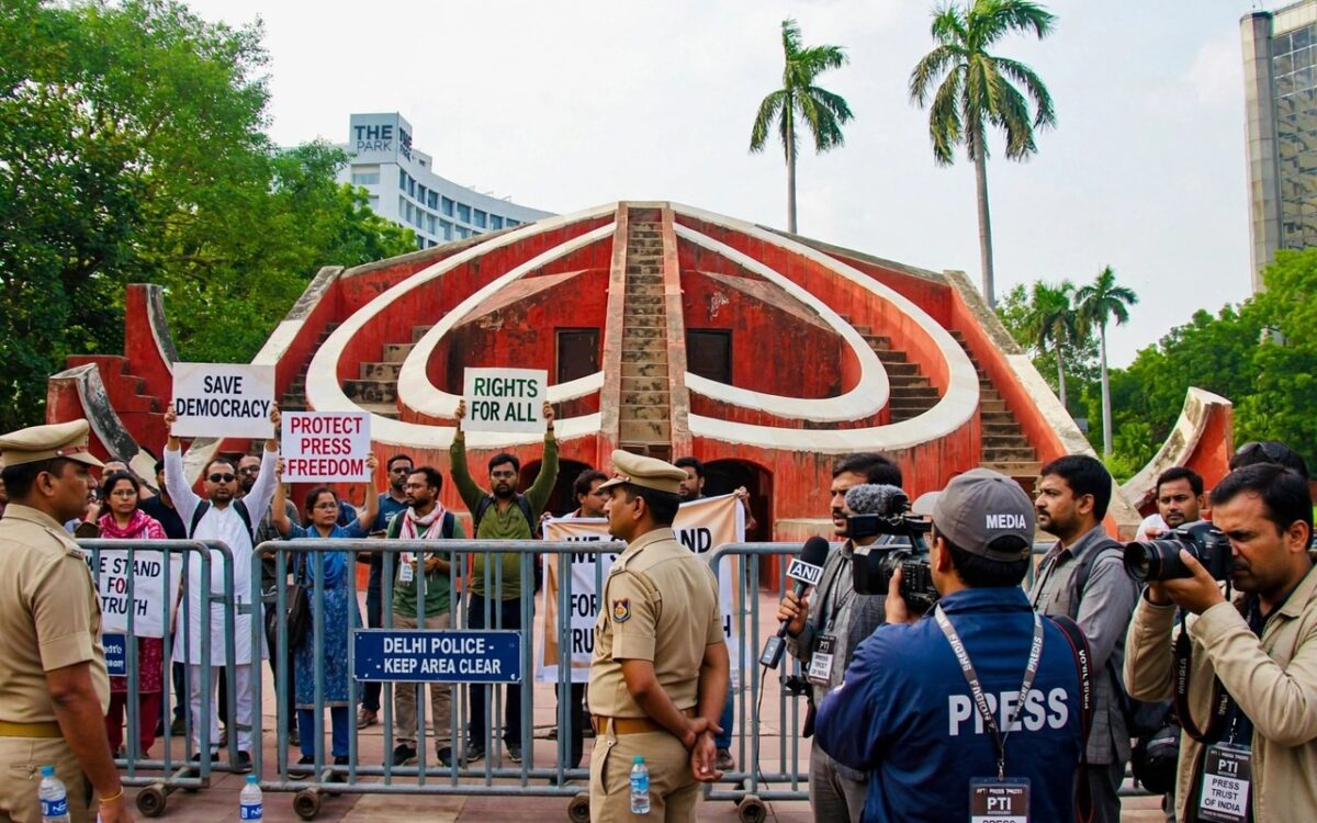 Protesters and journalists gathered at Jantar Mantar in New Delhi with police barricades